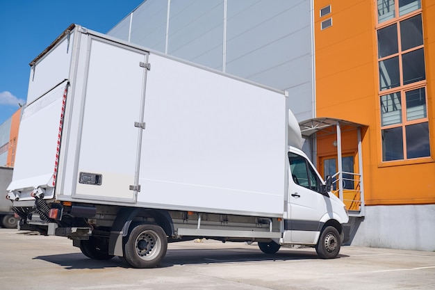 lorry-standing-outdoors-near-warehouse_259150-56932